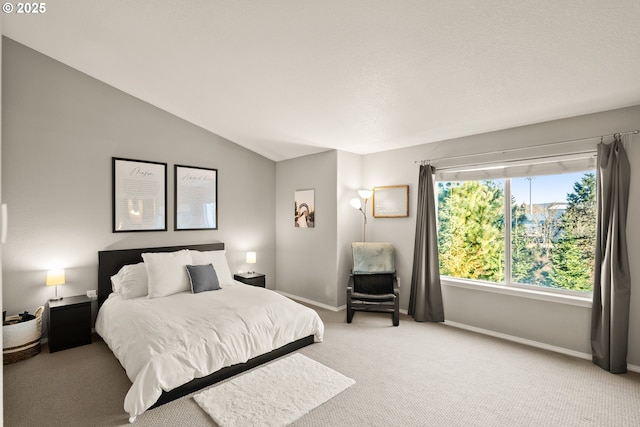 carpeted bedroom with vaulted ceiling