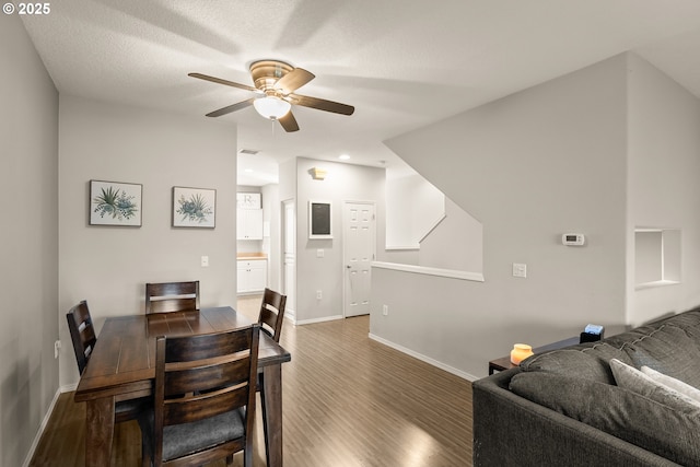 dining room with ceiling fan and dark hardwood / wood-style flooring