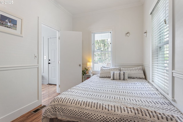 927 N Baldwin St, Portland, OR 97217 - bedroom featuring wood finished floors and crown molding
