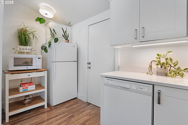 927 N Baldwin St, Portland, OR 97217 - kitchen with white appliances, light wood-style floors, light countertops, and white cabinetry
