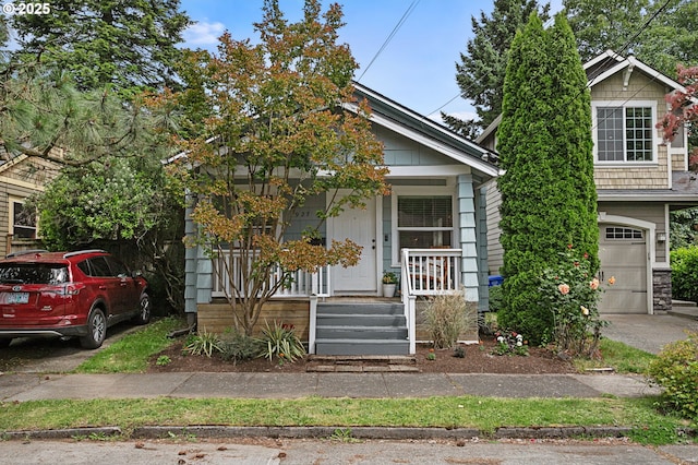 927 N Baldwin St, Portland, OR 97217 - obstructed view of property featuring a porch and a garage