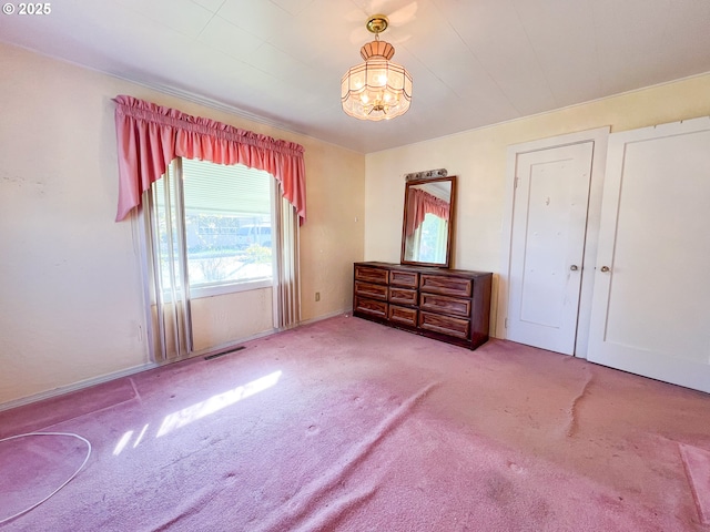 413 SW Brent Dr, John Day, OR 97845 - unfurnished bedroom with carpet, a chandelier, and baseboards