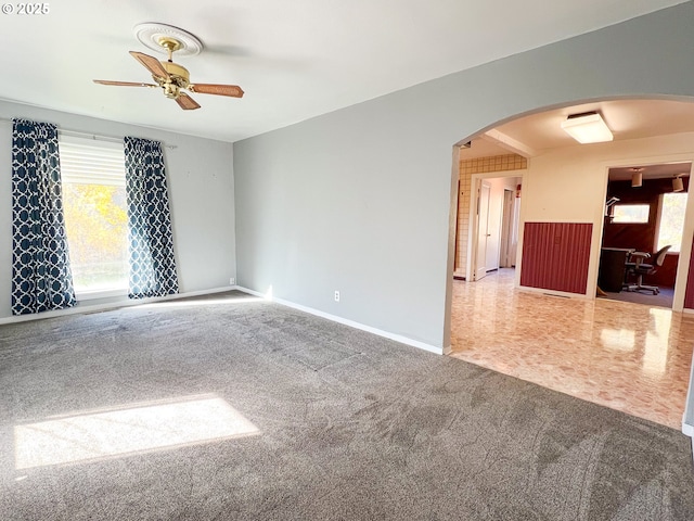 413 SW Brent Dr, John Day, OR 97845 - carpeted empty room with arched walkways, a ceiling fan, healthy amount of natural light, and baseboards