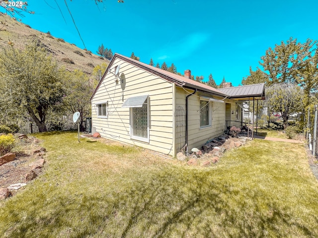 413 SW Brent Dr, John Day, OR 97845 - view of property exterior featuring a chimney and a lawn