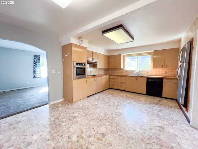 413 SW Brent Dr, John Day, OR 97845 - kitchen featuring appliances with stainless steel finishes, a sink, decorative backsplash, arched walkways, and light countertops