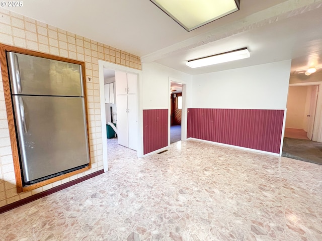 413 SW Brent Dr, John Day, OR 97845 - empty room featuring wainscoting and stone finish floors