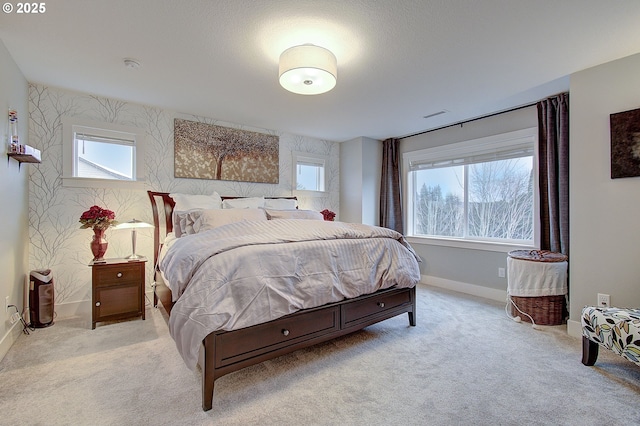 carpeted bedroom featuring multiple windows