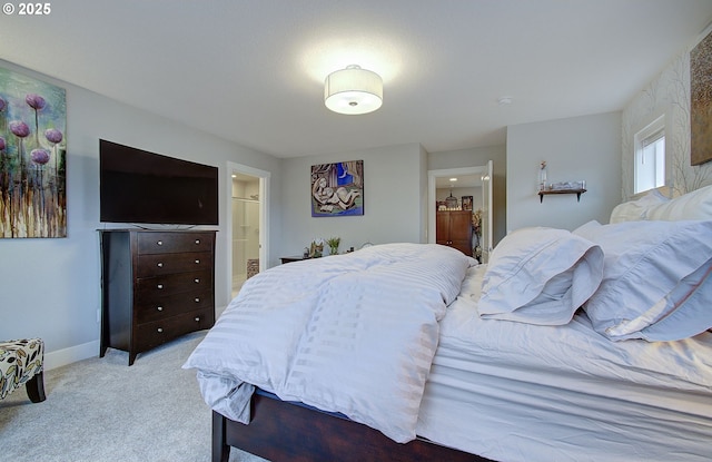 bedroom with light carpet and ensuite bath