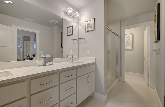 bathroom with vanity and a shower with shower door