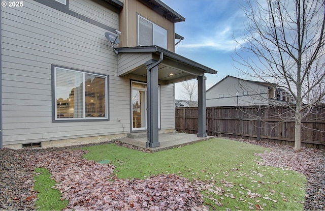 back of house with a patio and a yard