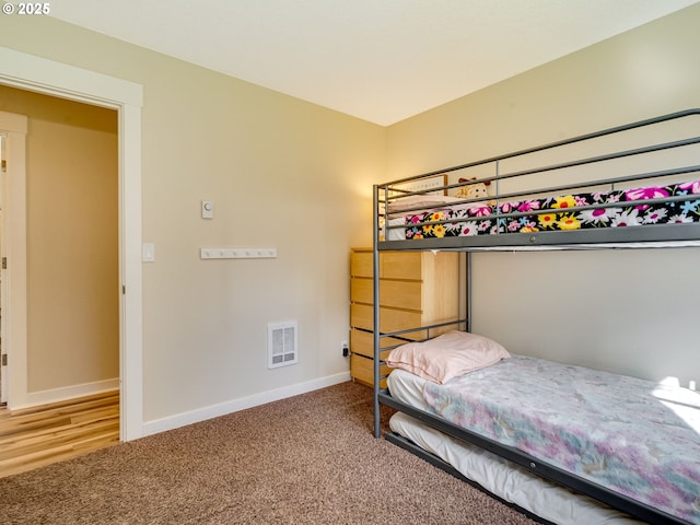 bedroom featuring carpet, visible vents, and baseboards