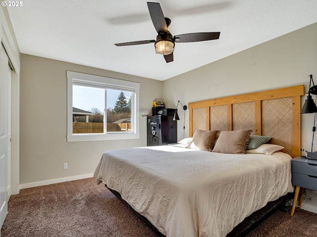 carpeted bedroom featuring a ceiling fan, a closet, and baseboards