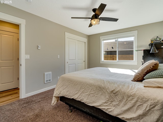 bedroom with carpet floors, a ceiling fan, visible vents, and baseboards