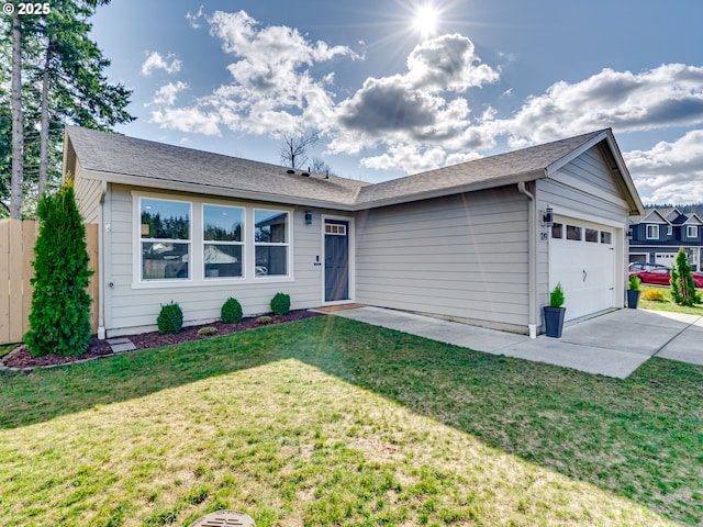 ranch-style home featuring a front yard, driveway, and an attached garage