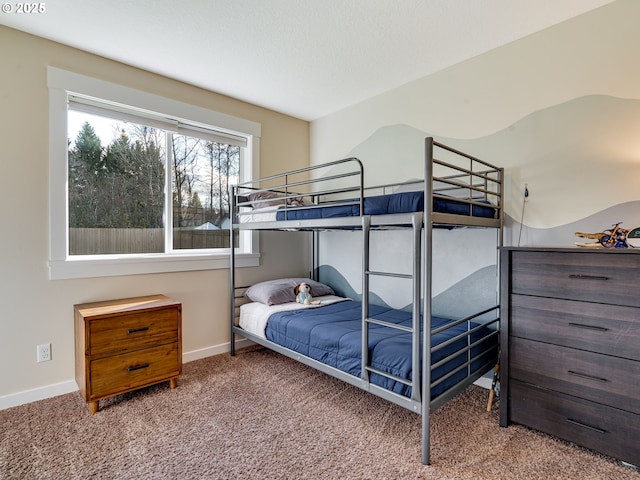 bedroom featuring carpet floors and baseboards