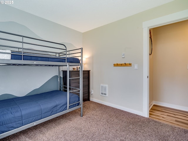 bedroom featuring carpet floors, visible vents, and baseboards