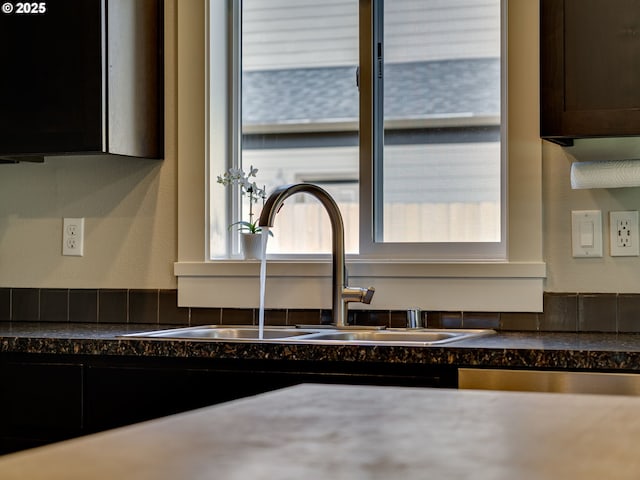 details with dark countertops, dark brown cabinetry, and a sink