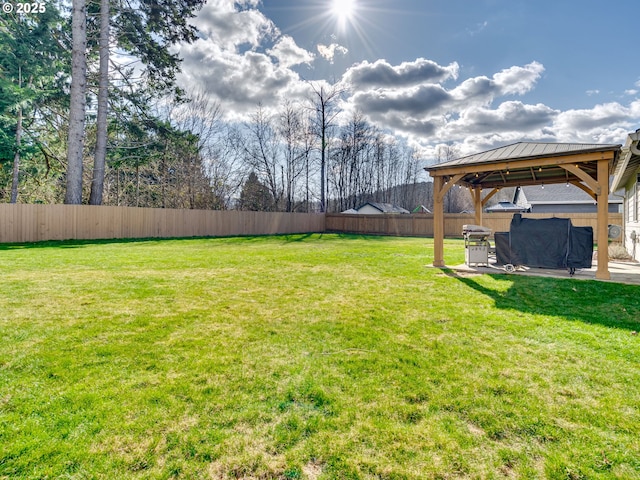 view of yard with fence and a gazebo