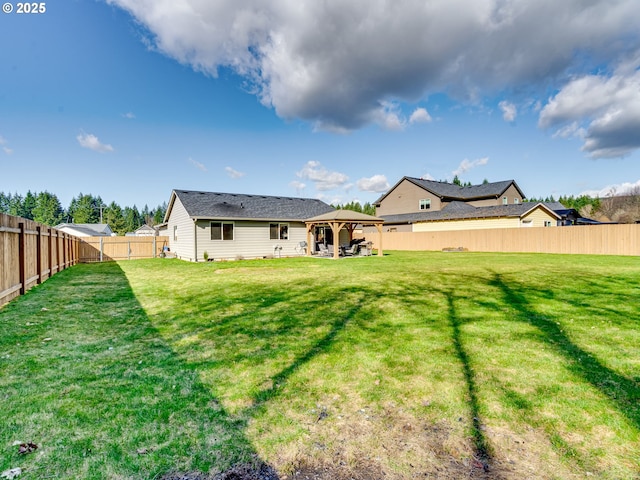 back of house featuring a patio area, a fenced backyard, a lawn, and a gazebo