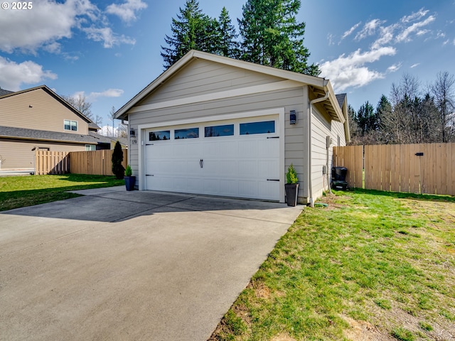 detached garage featuring fence