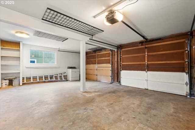 garage with visible vents, washer / dryer, and a garage door opener