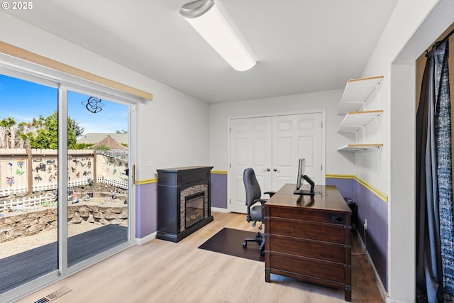 307 Cambridge Dr, Sutherlin, OR 97479 - office space featuring light wood-type flooring, a glass covered fireplace, and baseboards