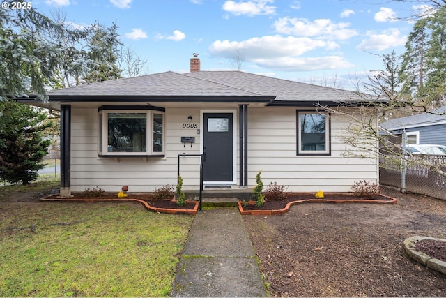 bungalow-style home with a front lawn