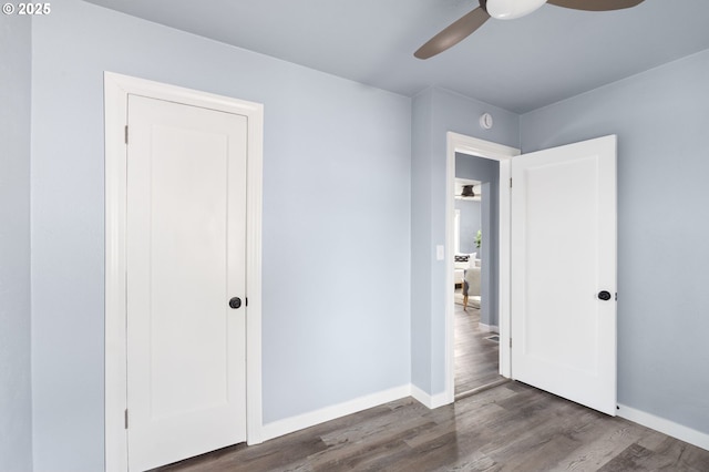 unfurnished bedroom with dark wood-type flooring and ceiling fan