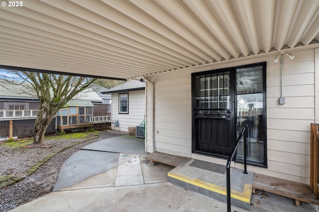 property entrance featuring a patio area