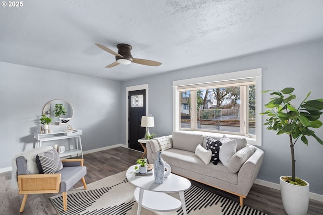 living room with ceiling fan, hardwood / wood-style floors, and a textured ceiling