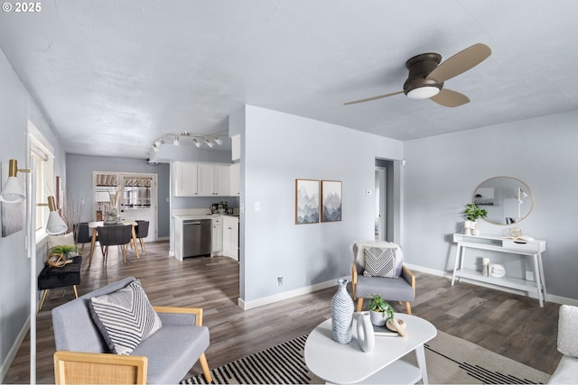 living room featuring rail lighting, dark hardwood / wood-style floors, and ceiling fan