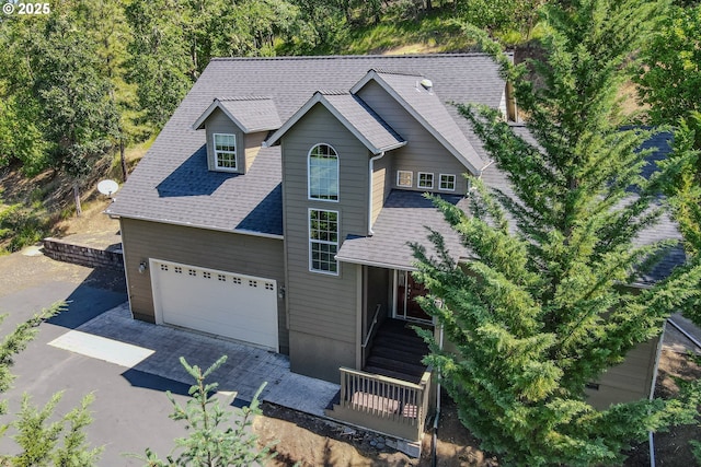 356 Wild Fern Dr, Winchester, OR 97495 - view of front facade featuring an attached garage, a shingled roof, and driveway