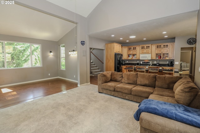 356 Wild Fern Dr, Winchester, OR 97495 - living room with vaulted ceiling, dark colored carpet, stairway, dark wood-style flooring, and baseboards