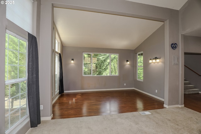 356 Wild Fern Dr, Winchester, OR 97495 - carpeted empty room with vaulted ceiling, stairway, baseboards, and wood finished floors