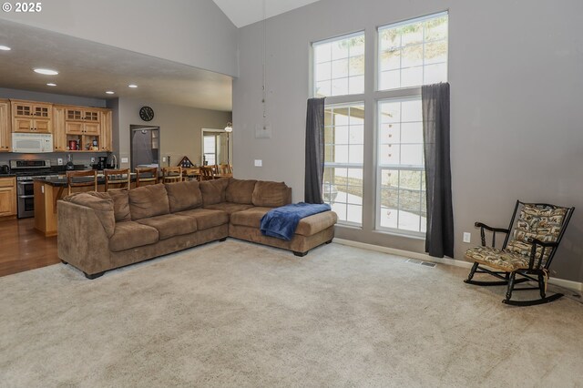 356 Wild Fern Dr, Winchester, OR 97495 - carpeted living room featuring plenty of natural light, recessed lighting, high vaulted ceiling, and baseboards