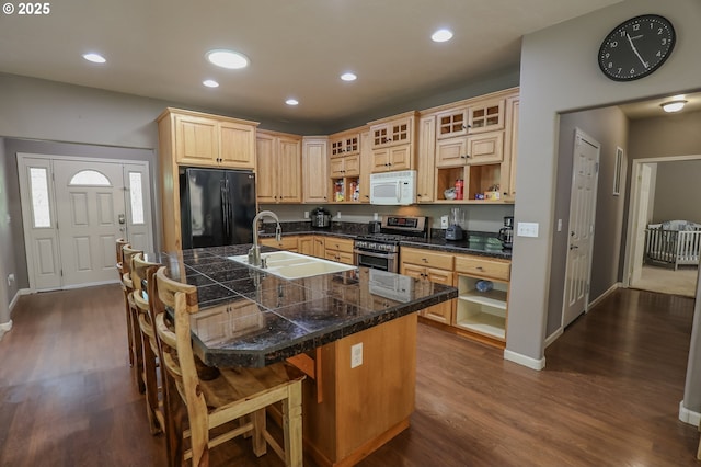 kitchen featuring freestanding refrigerator, white microwave, stainless steel range with gas stovetop, open shelves, and recessed lighting