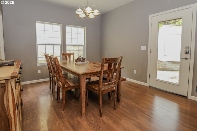dining room featuring a chandelier, wood finished floors, healthy amount of natural light, and baseboards