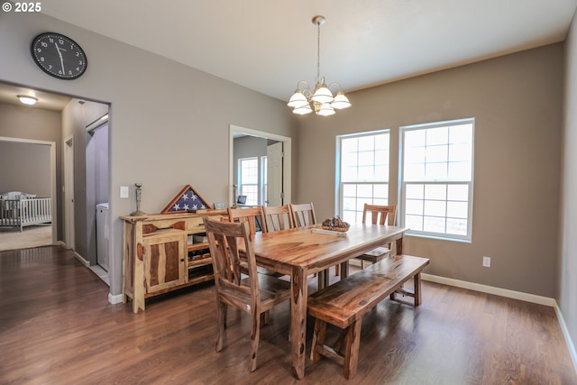 dining area with a chandelier, dark wood-style flooring, and baseboards