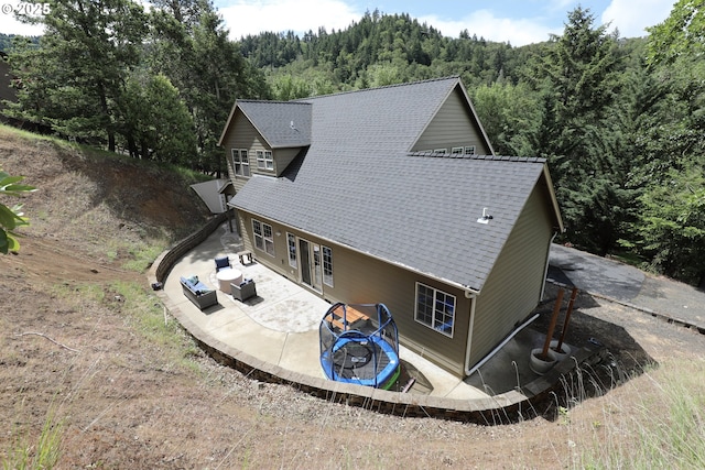 view of subject property with a forest