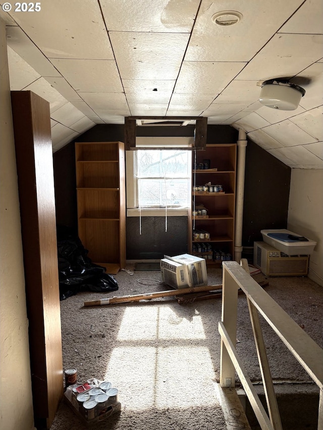 additional living space featuring vaulted ceiling and carpet flooring