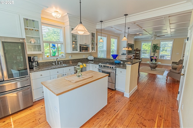 319 Kinnikinnick Way, Depoe Bay, OR 97341 - kitchen featuring stainless steel appliances, butcher block counters, a peninsula, open floor plan, and a center island