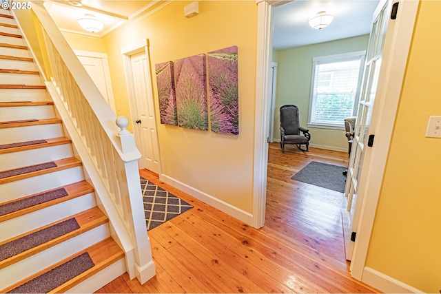 319 Kinnikinnick Way, Depoe Bay, OR 97341 - foyer featuring light wood finished floors, stairway, and ornamental molding