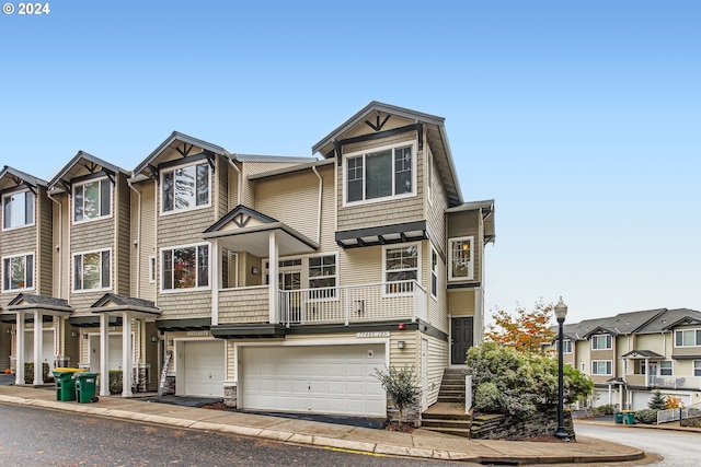 multi unit property featuring a garage and a residential view