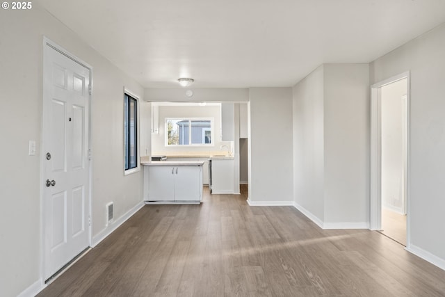 unfurnished living room featuring hardwood / wood-style flooring