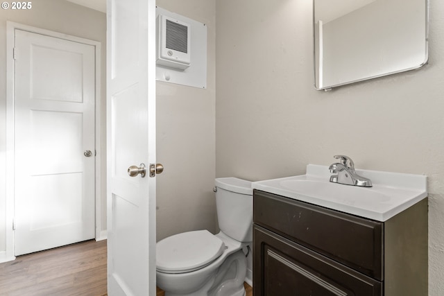 bathroom with vanity, hardwood / wood-style flooring, and toilet