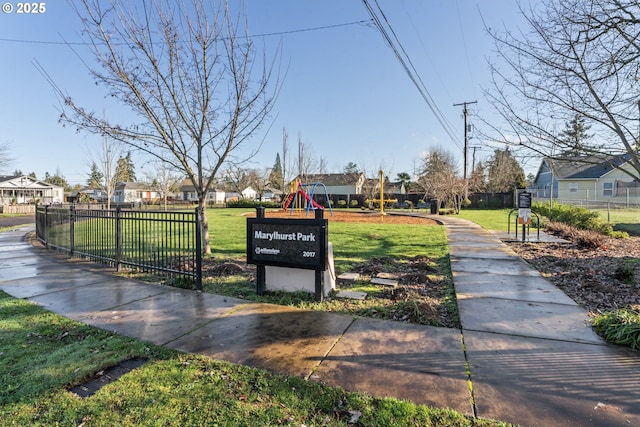 view of home's community with a playground and a lawn