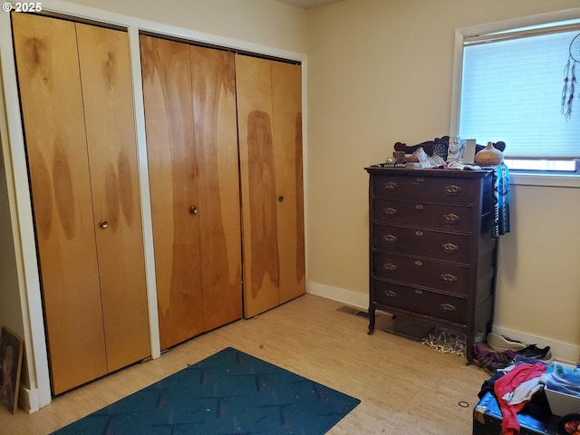 2640 Court Ave, Baker City, OR 97814 - bedroom with wood finished floors, two closets, and baseboards
