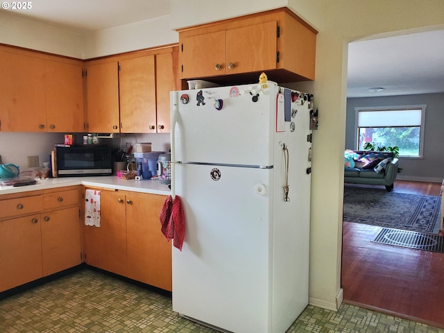 2640 Court Ave, Baker City, OR 97814 - kitchen featuring freestanding refrigerator, stainless steel microwave, and light countertops