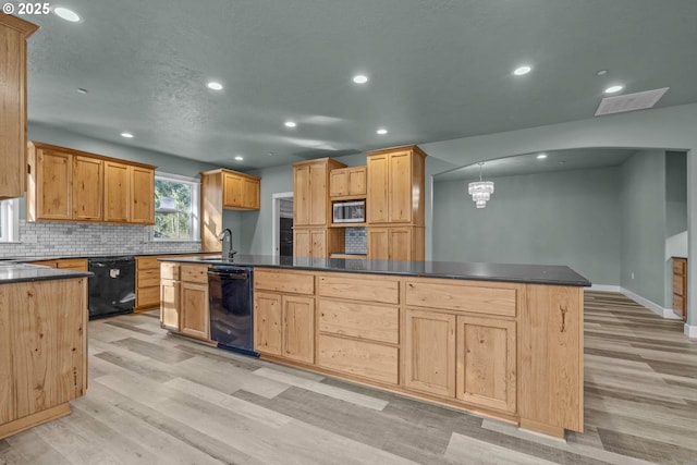 kitchen with a kitchen island with sink, backsplash, dishwasher, and light wood-type flooring