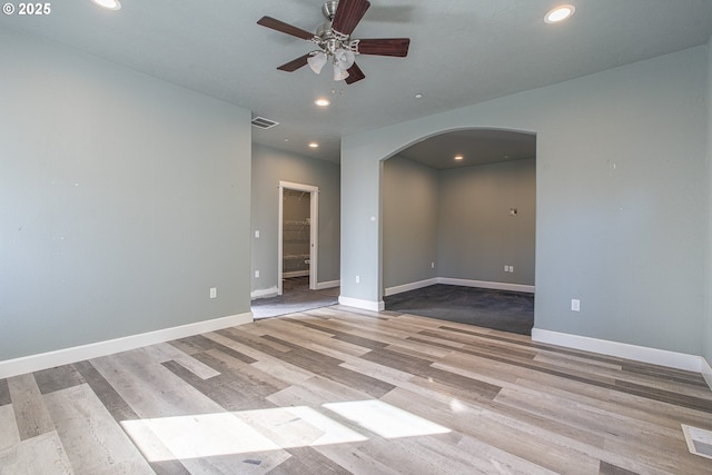 unfurnished room with ceiling fan and light hardwood / wood-style flooring